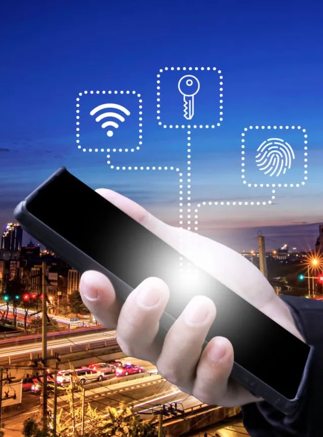 A hand holding a smartphone in front of a city skyline at dusk, with Wi-Fi, key and fingerprint icons